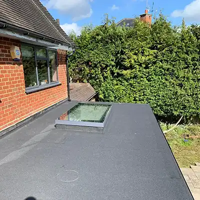 a black flat roof with a velux